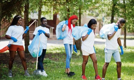 african eco-hero volunteers with garbage bags cleaning